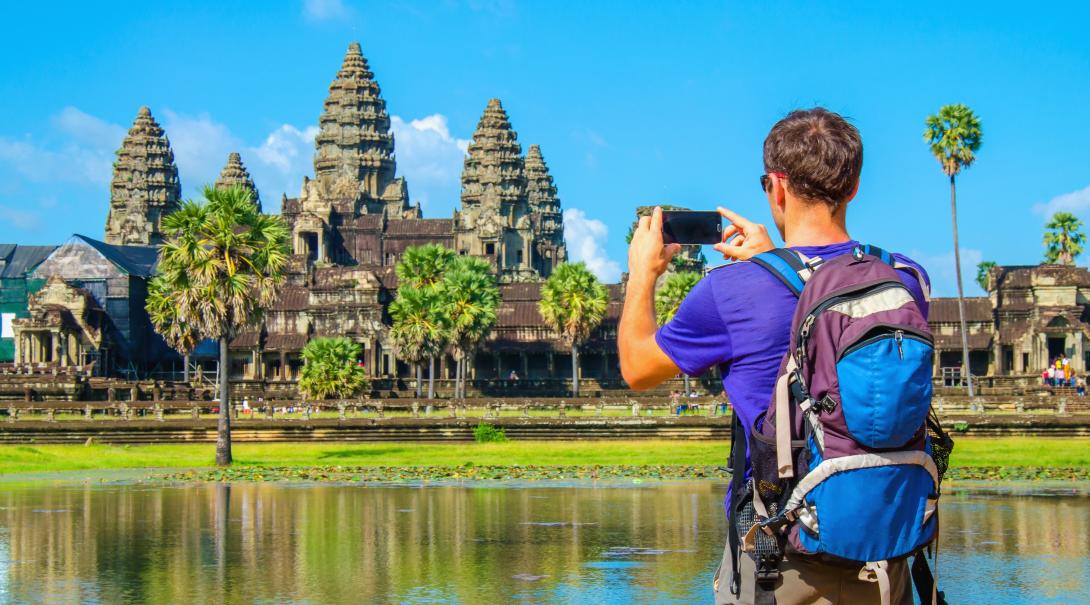 Projects Abroad volunteer explores Cambodia during his free time. Traveller takes a photo of Angkor Wat during his travels through Cambodia.